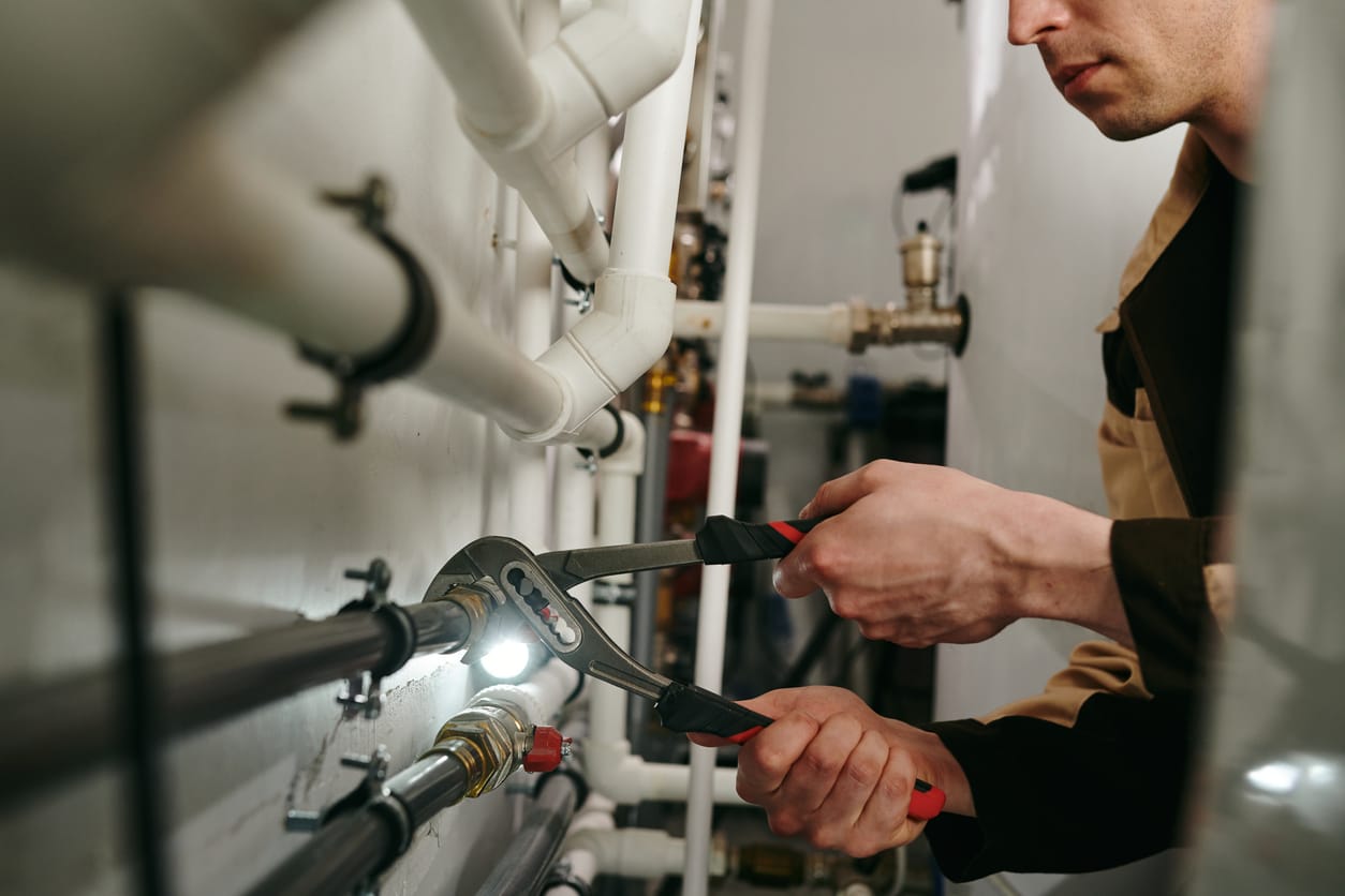 Plumbers maintaining commercial plumbing pipes in Newnan