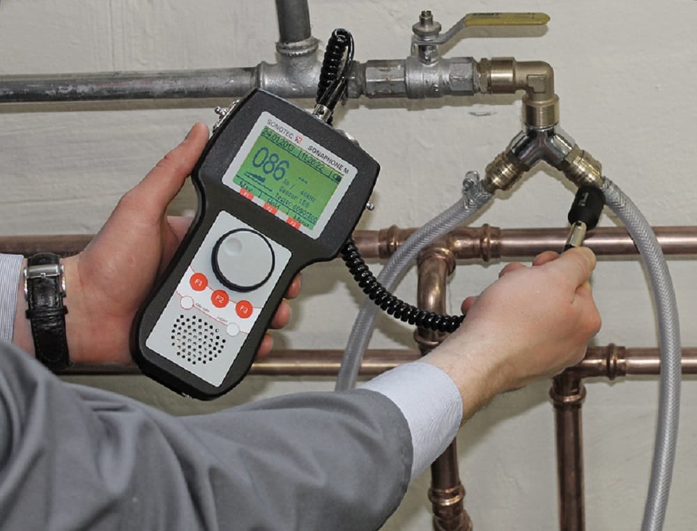 Plumber testing pipes with electronic leak detection equipment in Newnan