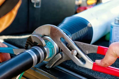 Technician tightening an industrial pipe connection in Newnan
