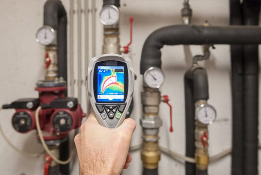 Plumber using a thermal imaging camera to inspect pipes in Newnan