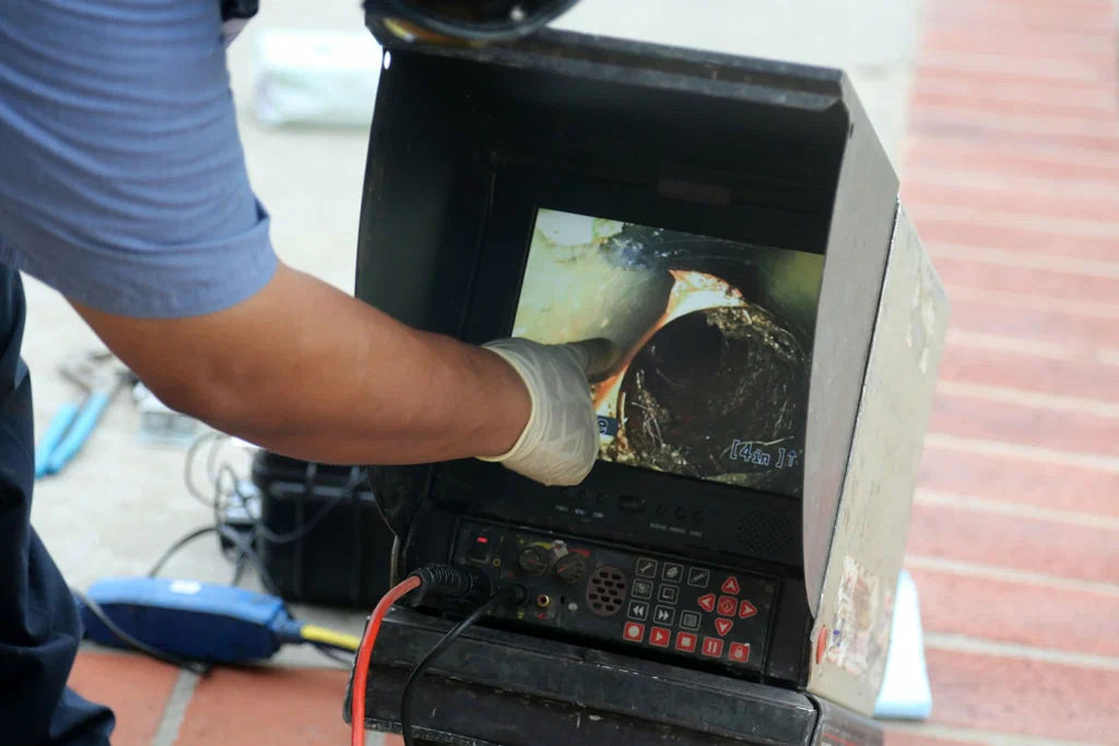 Technician viewing a drain inspection camera in Newnan