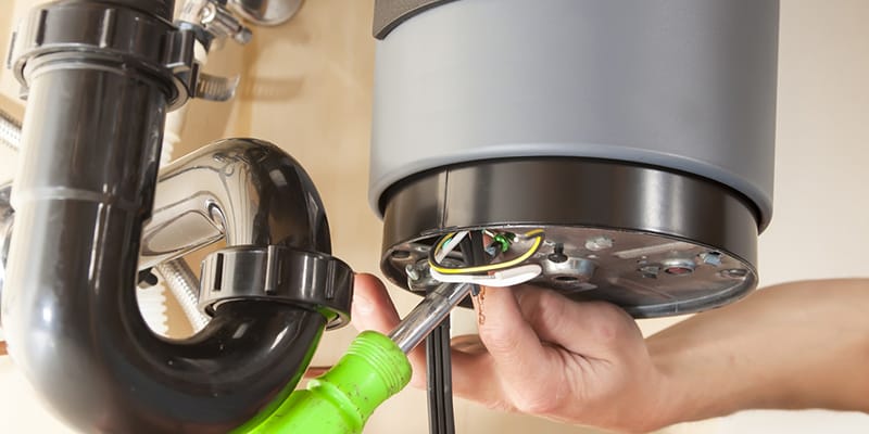 Technician repairing the heating element of a water heater in Newnan